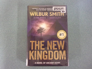 The New Kingdom: The Egyptian, Book 7 by Wilbur Smith and Mark Chadbourn (HC/DJ) *Has a library sticker on inside of back cover - no other library markings.*